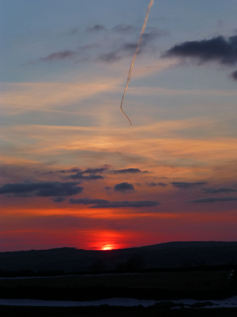 Sunset and contrail
